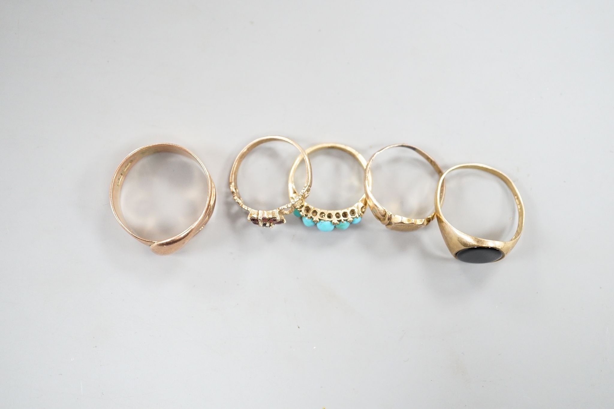 Four assorted 9ct rings including serpent(tired), signet and two gem set gross 10 grams and a yellow metal and five stone turquoise set ring, gross 3.6 grams.